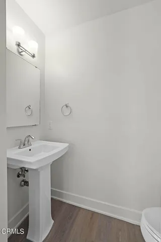 a bathroom with a sink a toilet and mirror
