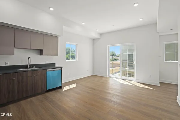 a kitchen with wooden floors and a sink