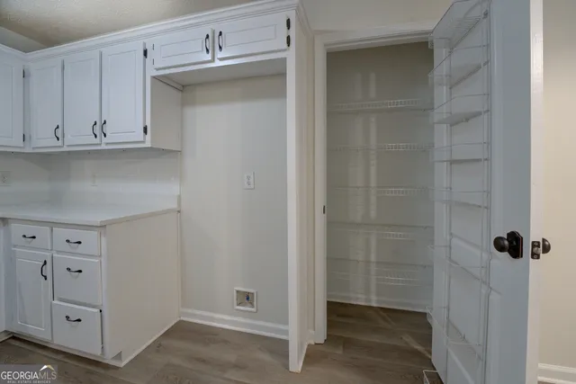a bathroom with white cabinets