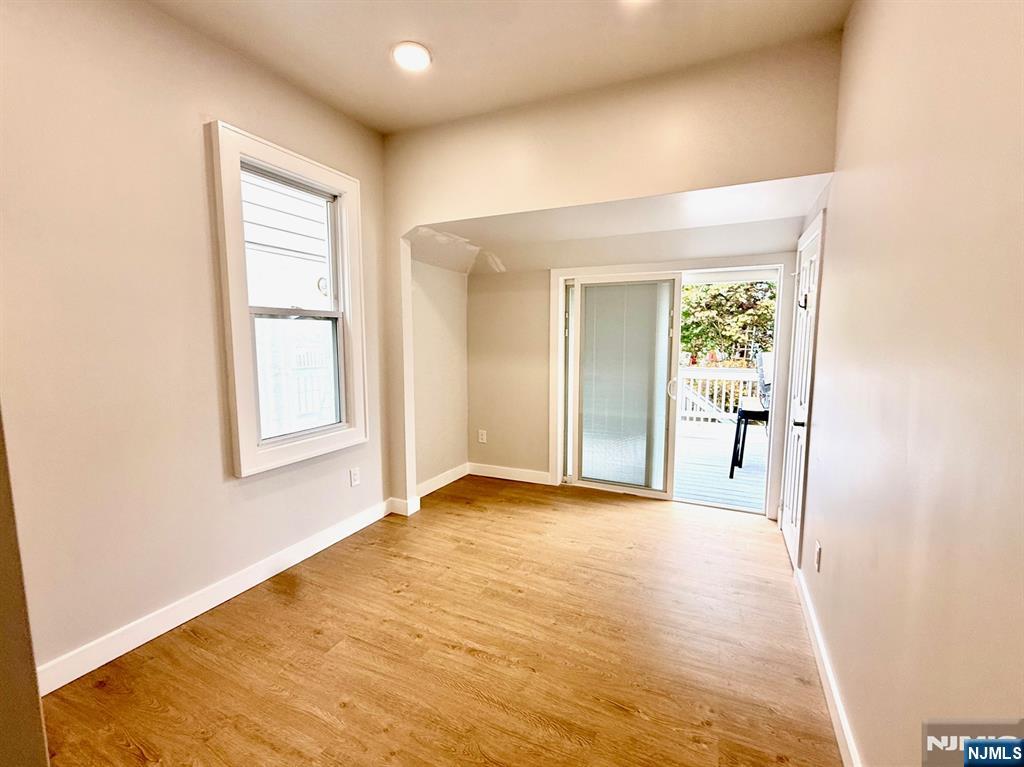 144 Centre Avenue Secaucus, NJ 07094 - Photo 15 of 22 a view of an empty room with glass door and a window