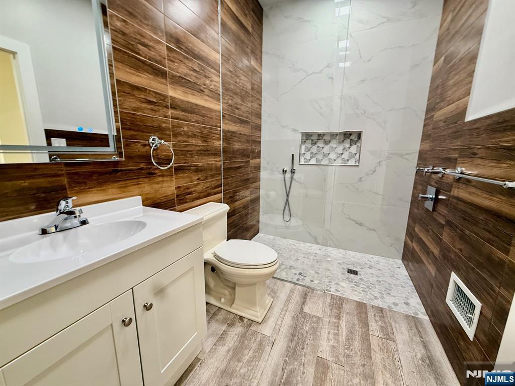 144 Centre Avenue Secaucus, NJ 07094 - Photo 3 of 22 a bathroom with a sink a toilet and shower