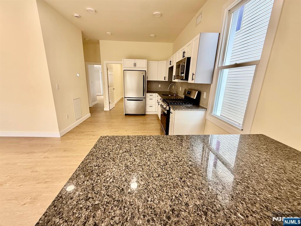 144 Centre Avenue Secaucus, NJ 07094 - Photo 8 of 22 a living room with stainless steel appliances kitchen island granite countertop a refrigerator and a sink