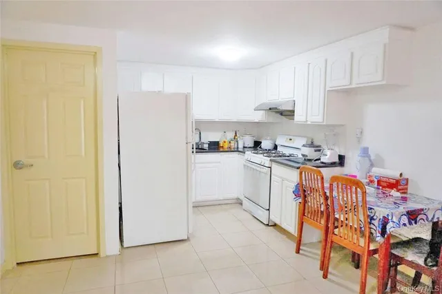 a kitchen with stainless steel appliances granite countertop a refrigerator sink and cabinets