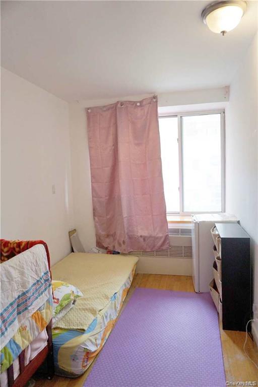 43-17 Union Street, Unit 6E Queens, NY 11355 - Photo 4 of 7 a bedroom with a bed and a window