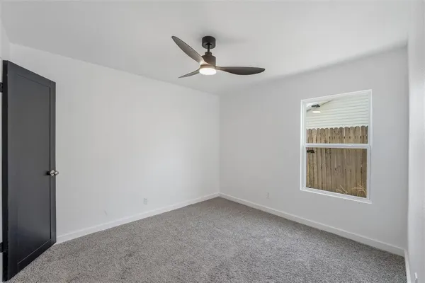 a big room with closet and a ceiling fan