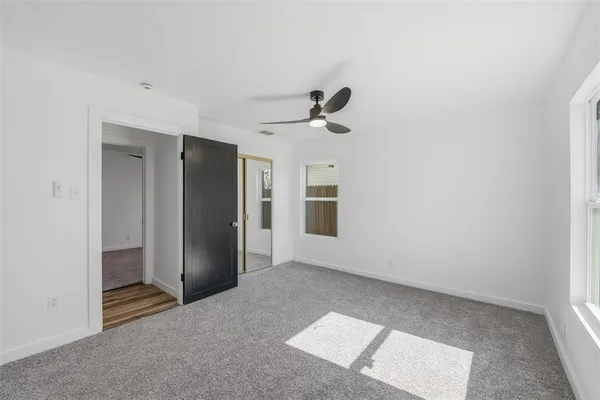 a bathroom with a tub a sink and a window