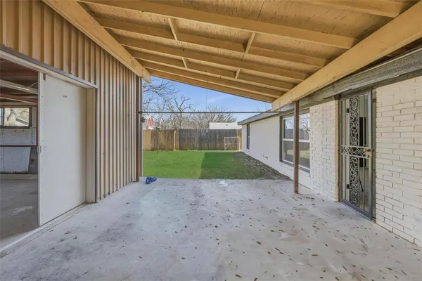 a view of room with wooden floor and fan