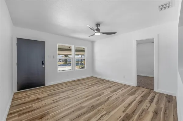 a view of a house with backyard and a tree