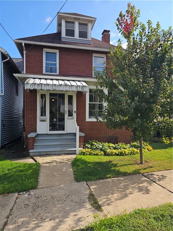 a front view of a house with a yard