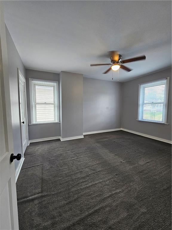 952 Roup Avenue Brackenridge, PA 15014 - Photo 16 of 25 an empty room with windows and chandelier fan