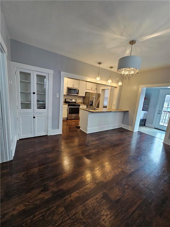 952 Roup Avenue Brackenridge, PA 15014 - Photo 6 of 25 a view of a living room and kitchen with furniture and wooden floor