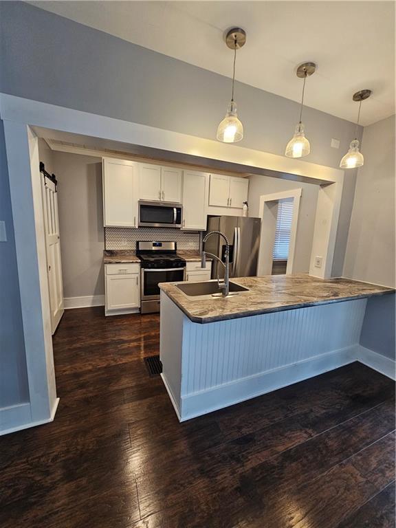 952 Roup Avenue Brackenridge, PA 15014 - Photo 7 of 25 a kitchen with wooden floors and a refrigerator