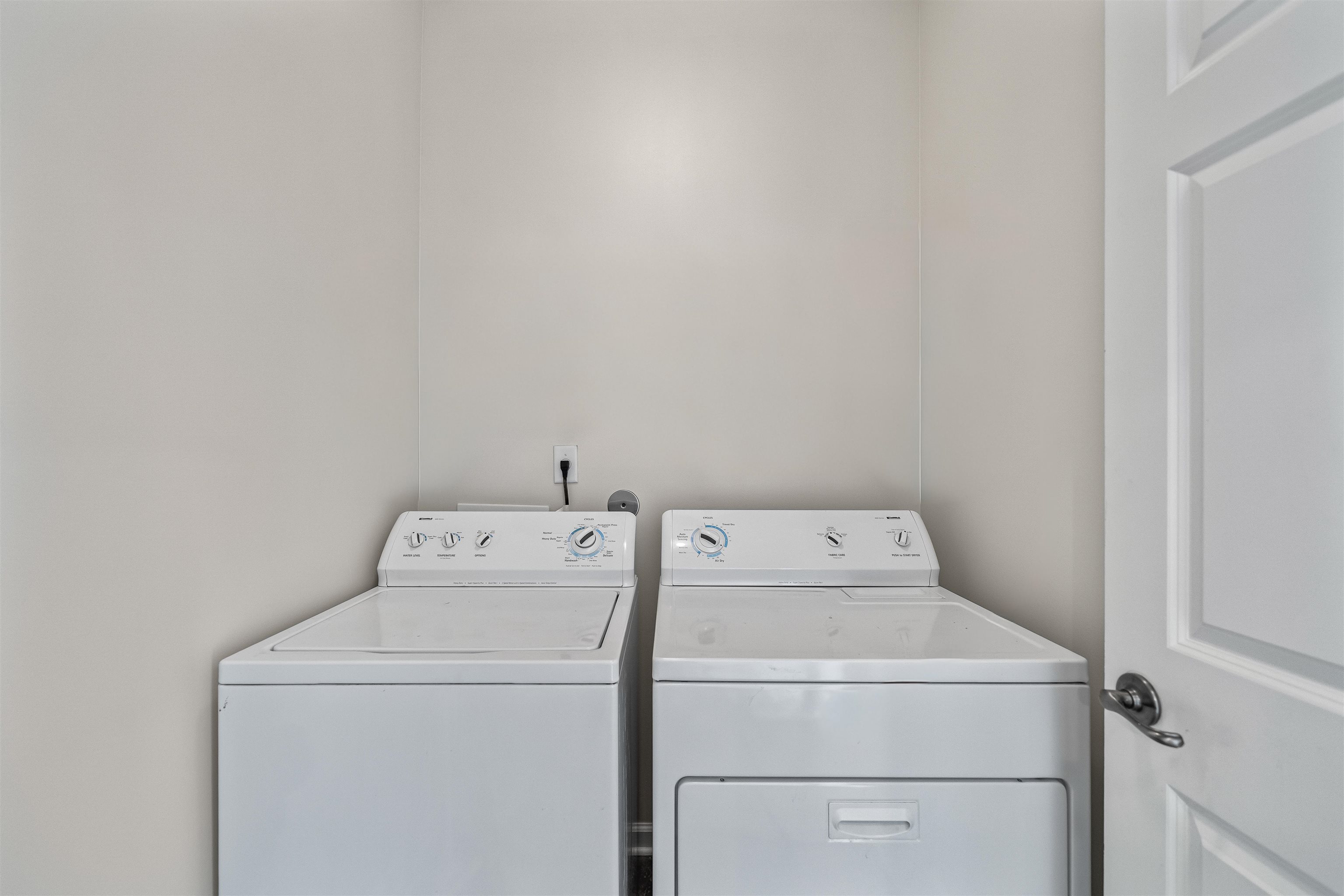 5035 Brian Ridge Road Arlington, TN 38002 - Photo 27 of 40 Dedicated laundry area featuring a white top-load washer and a white front-load dryer, with light-toned wall finishes
