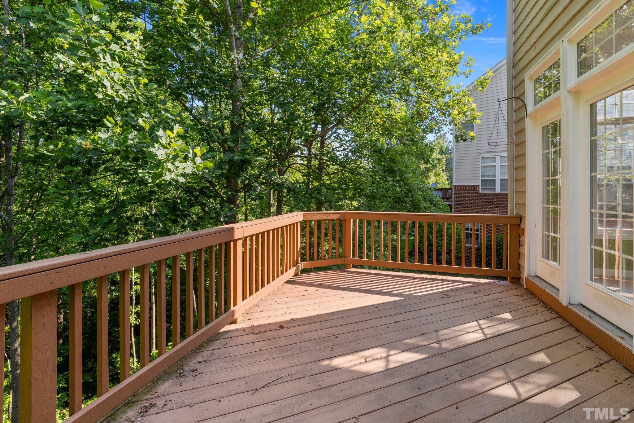 6831 Middleboro Drive Raleigh, NC 27612 - Photo 12 of 32 a balcony view with wooden floor and fence