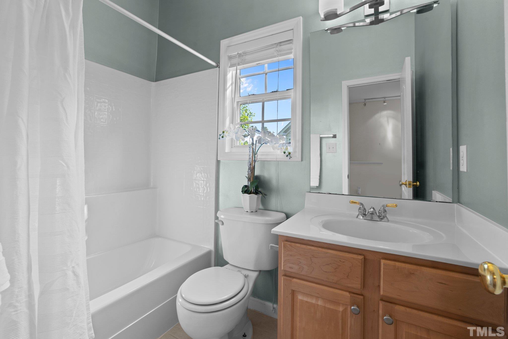 6831 Middleboro Drive Raleigh, NC 27612 - Photo 20 of 32 a bathroom with a sink a toilet and shower