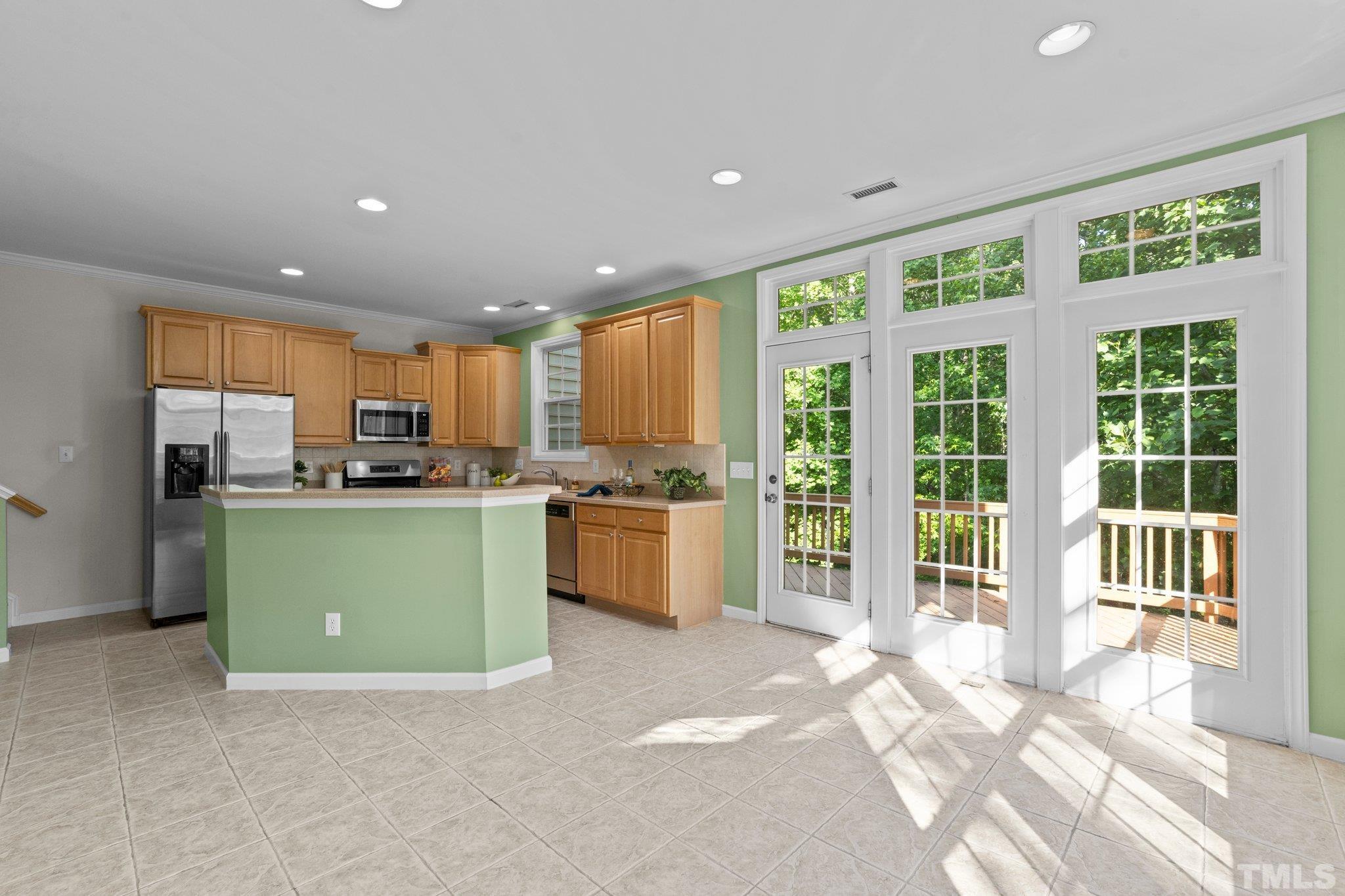 6831 Middleboro Drive Raleigh, NC 27612 - Photo 7 of 32 a kitchen with a refrigerator and a sink