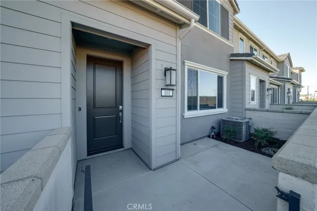 a view of house with a bench and potted plants