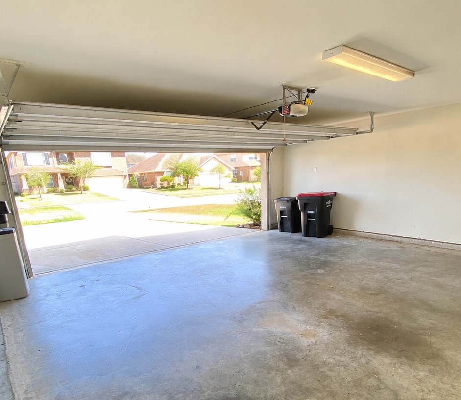 5002 Naples Grove Lane Rosharon, TX 77583 - Photo 34 of 38 Spacious two-car garage with a clean concrete floor and convenient access to the driveway and street.