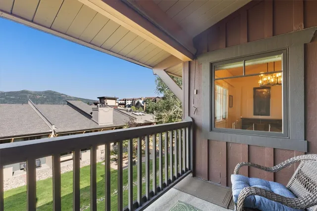 a view of a chairs and table in the balcony