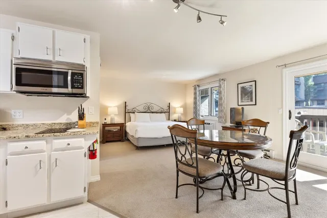 a kitchen with granite countertop white cabinets and appliances