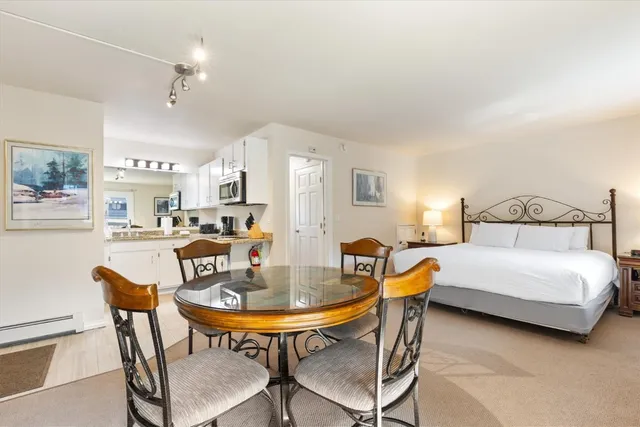 a view of a dining room with furniture and a chandelier