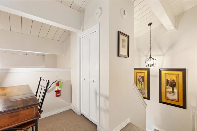 a view of a hallway with seating area