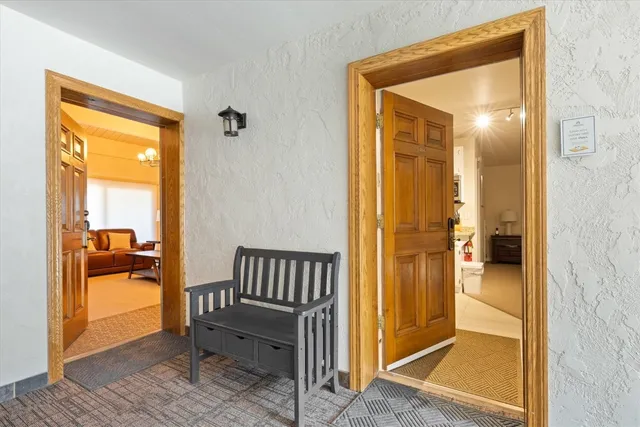 a view of a hallway with a door and couch
