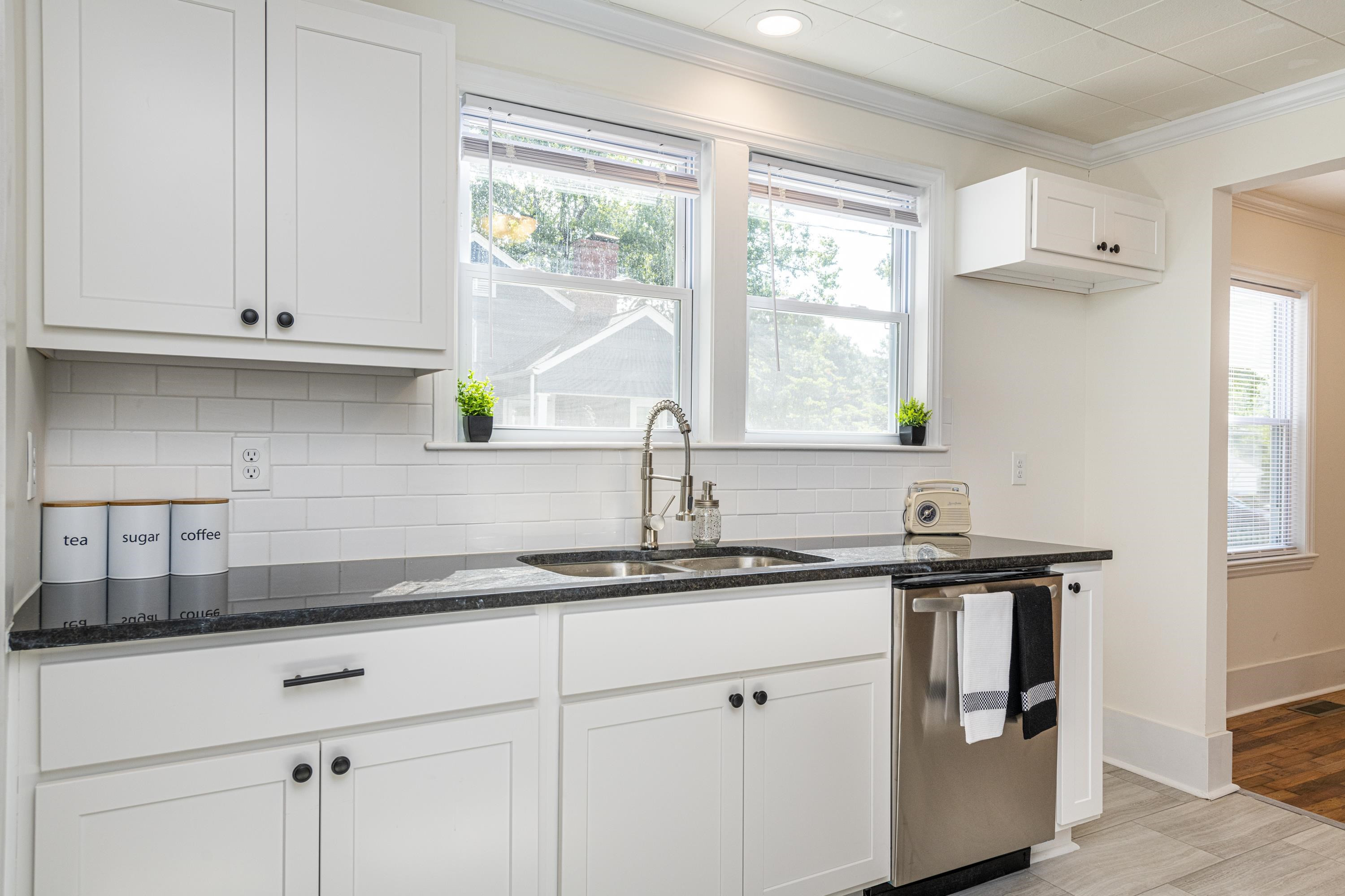 2523 Rochelle Street Durham, NC 27703 - Photo 17 of 31 a kitchen with stainless steel appliances granite countertop a sink a cabinets and a window