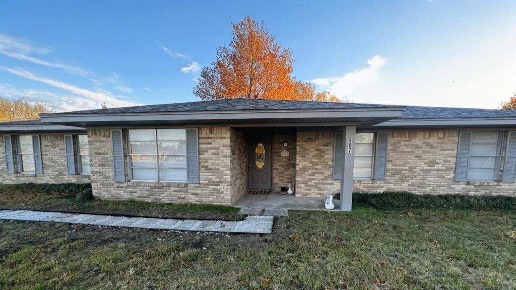 4075 Old Bonham Road Paris, TX 75460 - Photo 1 of 20 a front view of a house with garden