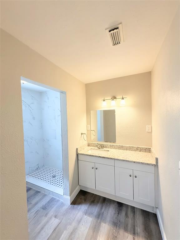 4075 Old Bonham Road Paris, TX 75460 - Photo 13 of 20 a bathroom with a granite countertop sink mirror and shower