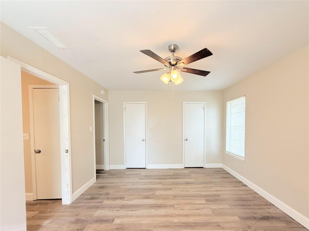 4075 Old Bonham Road Paris, TX 75460 - Photo 14 of 20 an empty room with wooden floor and window