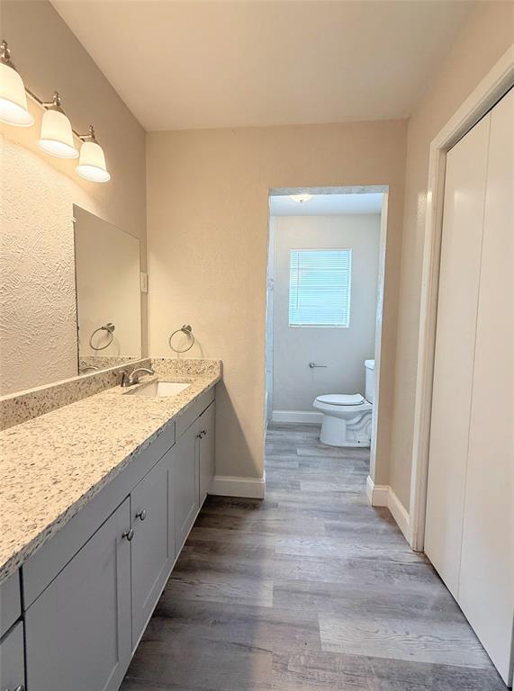 4075 Old Bonham Road Paris, TX 75460 - Photo 18 of 20 a spacious bathroom with a granite countertop sink and a toilet