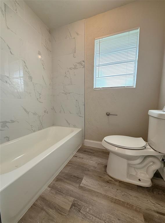 4075 Old Bonham Road Paris, TX 75460 - Photo 19 of 20 a white toilet sitting next to a bath tub