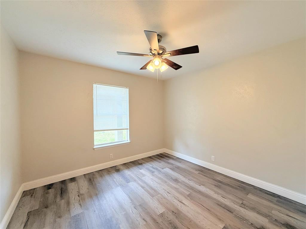 4075 Old Bonham Road Paris, TX 75460 - Photo 20 of 20 an empty room with a window and a fan