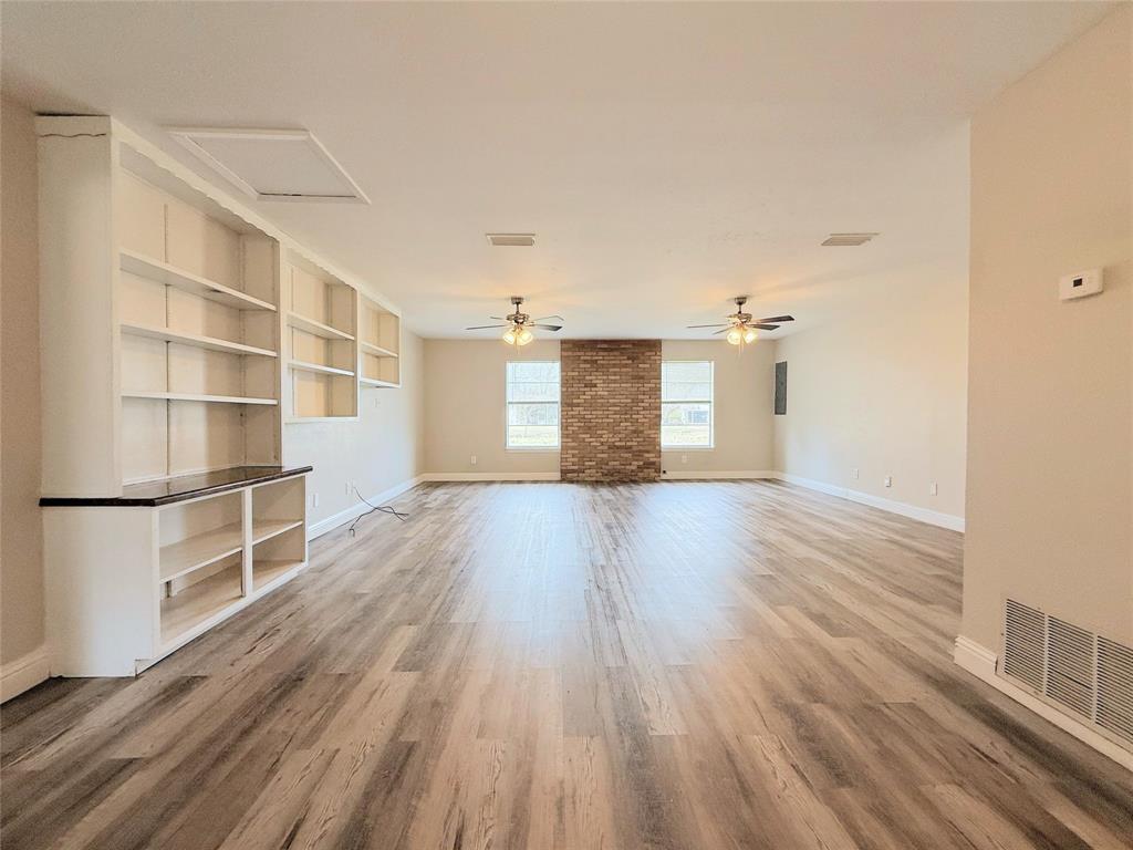 4075 Old Bonham Road Paris, TX 75460 - Photo 6 of 20 a view of a room with wooden floor and white walls