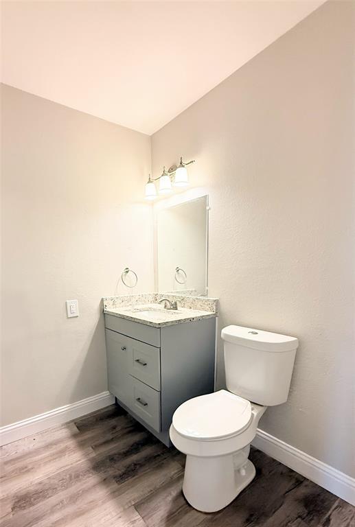 4075 Old Bonham Road Paris, TX 75460 - Photo 7 of 20 a bathroom with a toilet a sink and mirror