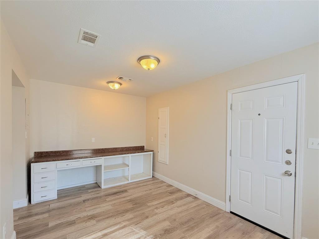4075 Old Bonham Road Paris, TX 75460 - Photo 8 of 20 a view of an empty room with wooden floor