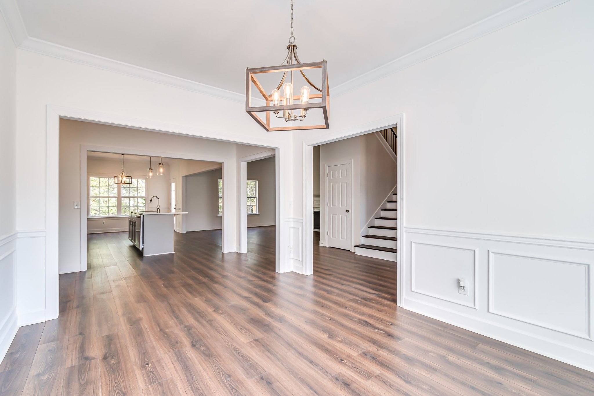 5126 Reagan Drive Murfreesboro, TN 37129 - Photo 4 of 20 a view of a room with wooden floor staircase and a kitchen space