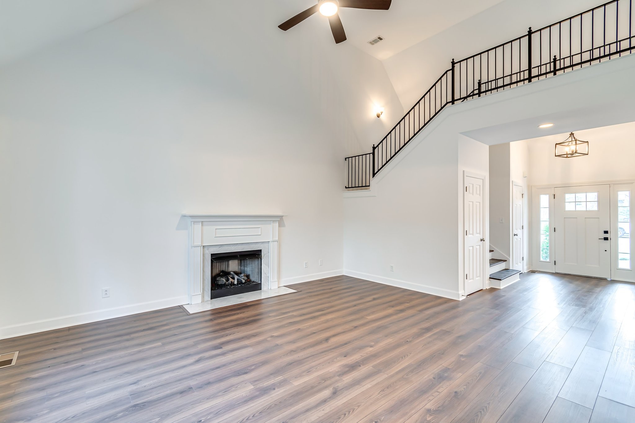 5126 Reagan Drive Murfreesboro, TN 37129 - Photo 5 of 20 an empty room with wooden floor fireplace and windows