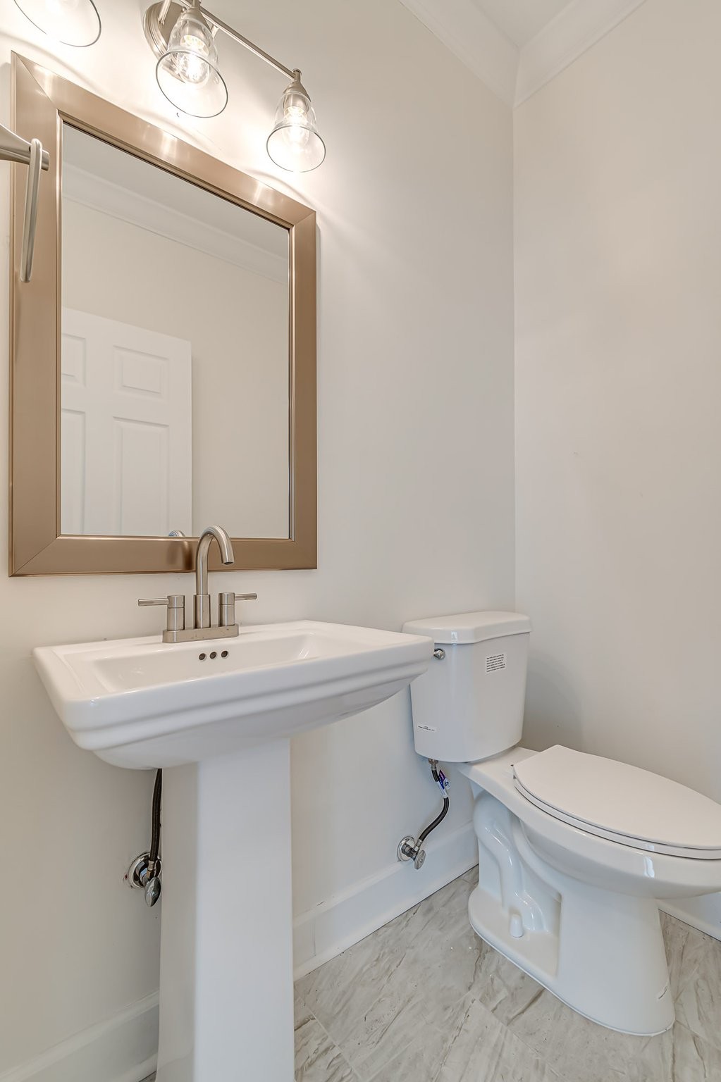 5126 Reagan Drive Murfreesboro, TN 37129 - Photo 8 of 20 a bathroom with a toilet a sink and mirror