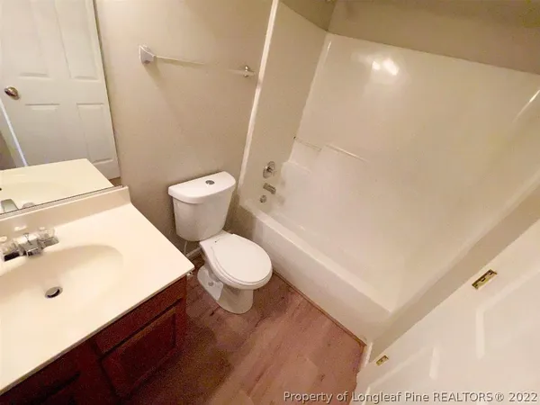a white toilet sitting next to a bathroom sink