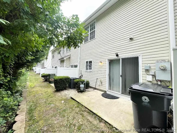 a view of a backyard with sitting area
