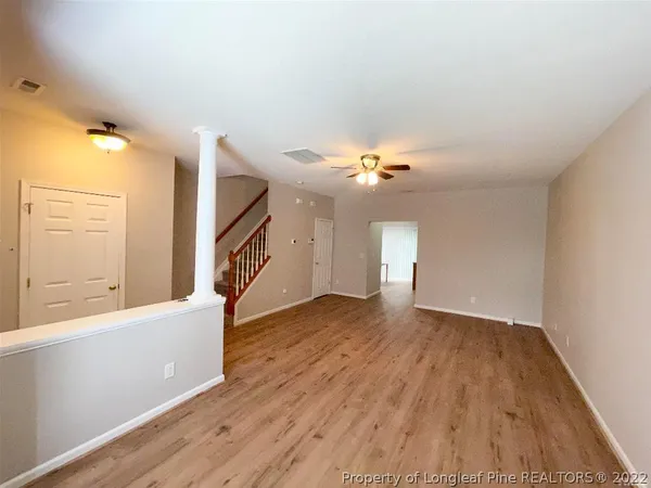 wooden floor in an empty room with a window
