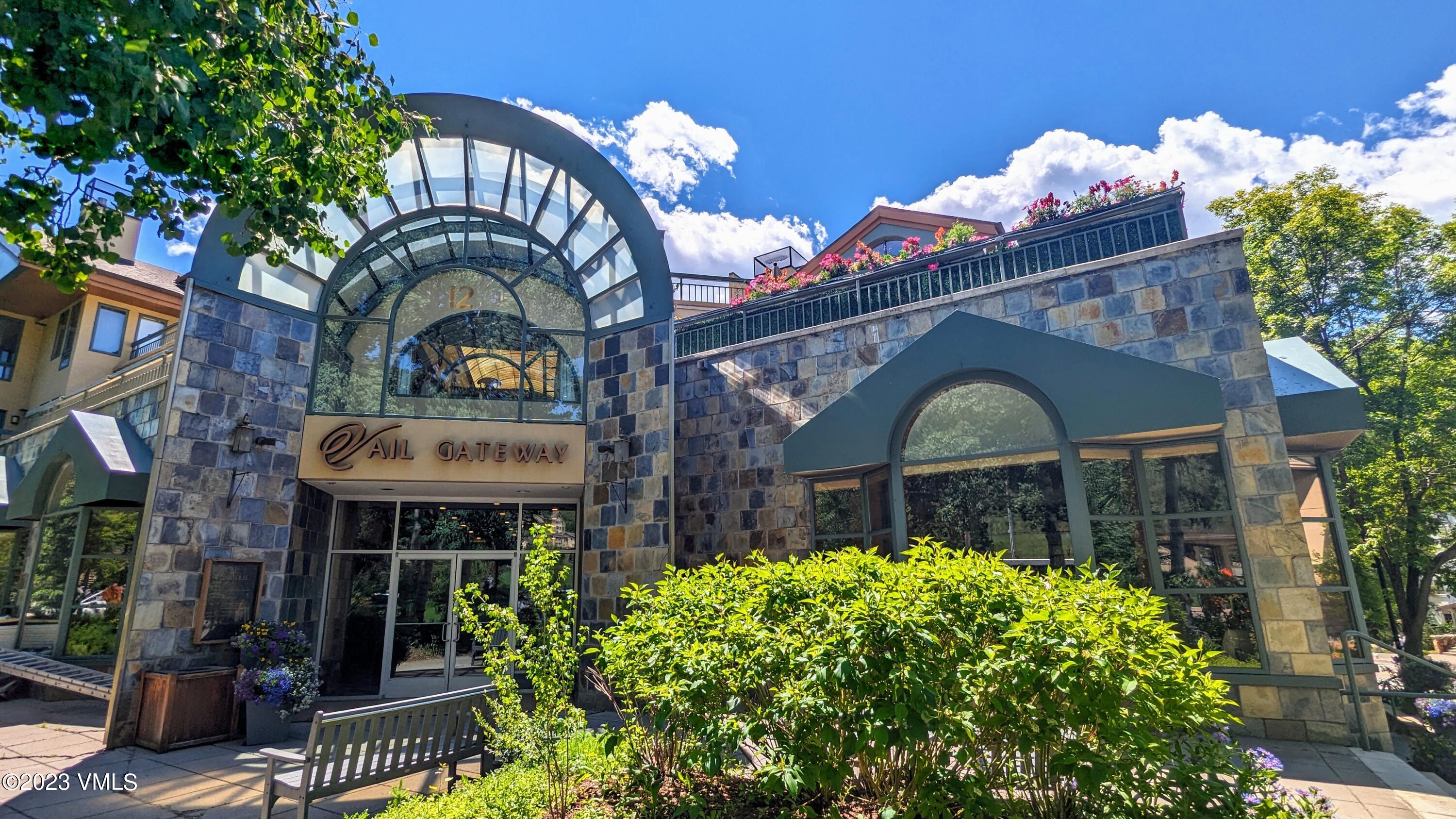 12 Vail Road, Unit P13 Vail, CO 81657 - Photo 2 of 3 a front view of house along with deck and outdoor seating