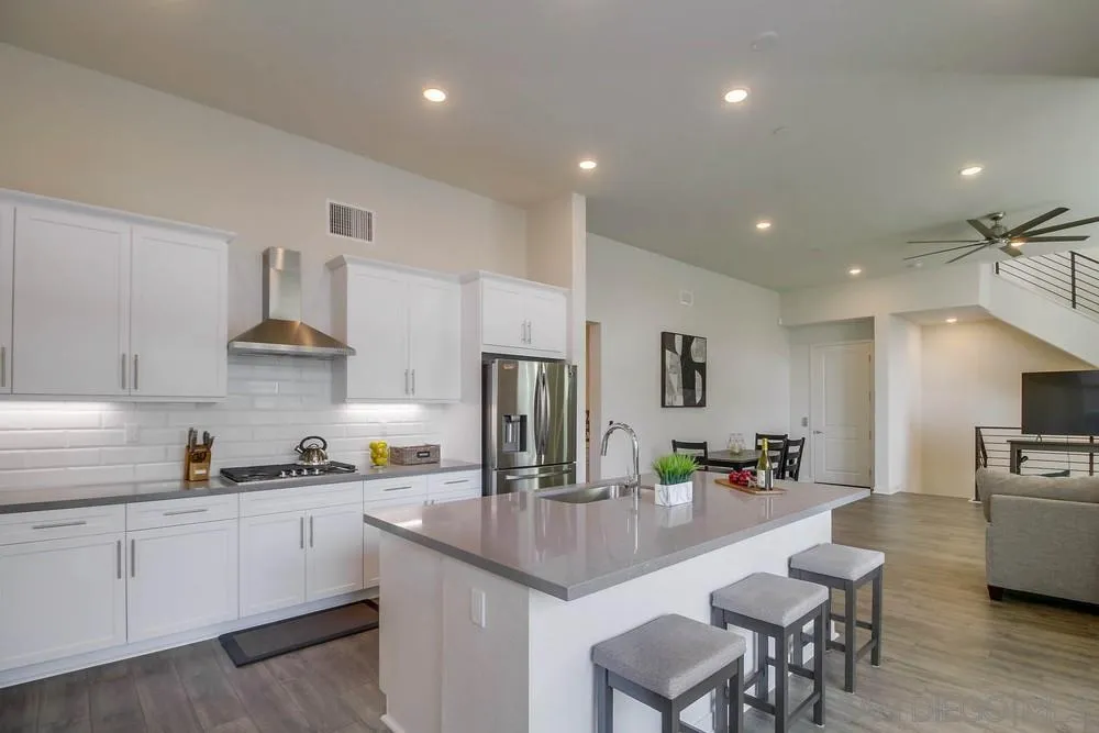 2035 Bravo Loop, Unit 6 Chula Vista, CA 91915 - Photo 11 of 39 a kitchen with cabinets a sink stainless steel appliances and dining table