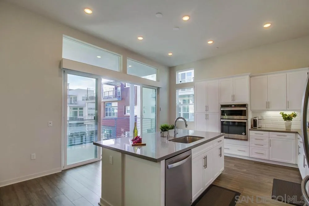 2035 Bravo Loop, Unit 6 Chula Vista, CA 91915 - Photo 12 of 39 a kitchen with granite countertop a stove and cabinets