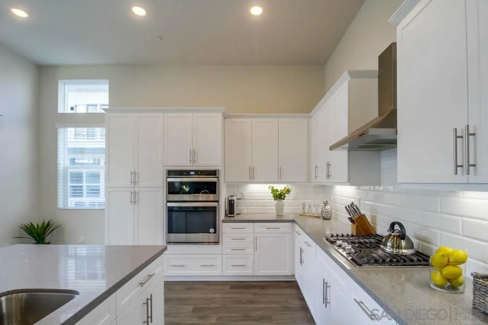 2035 Bravo Loop, Unit 6 Chula Vista, CA 91915 - Photo 13 of 39 a kitchen with granite countertop a sink a counter space appliances and cabinets