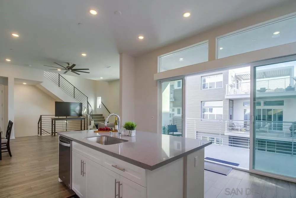 2035 Bravo Loop, Unit 6 Chula Vista, CA 91915 - Photo 15 of 39 a kitchen with counter top space and wooden floor