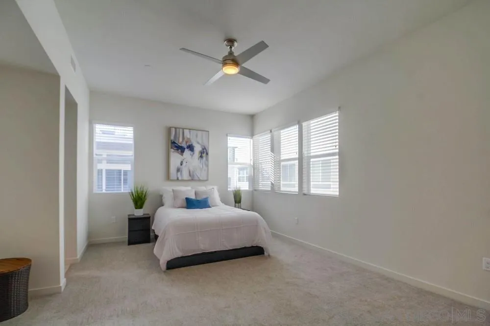 2035 Bravo Loop, Unit 6 Chula Vista, CA 91915 - Photo 19 of 39 a bedroom with a bed and window