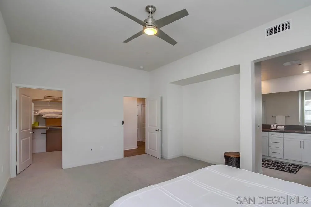 2035 Bravo Loop, Unit 6 Chula Vista, CA 91915 - Photo 20 of 39 a bedroom with a bed and a chandelier